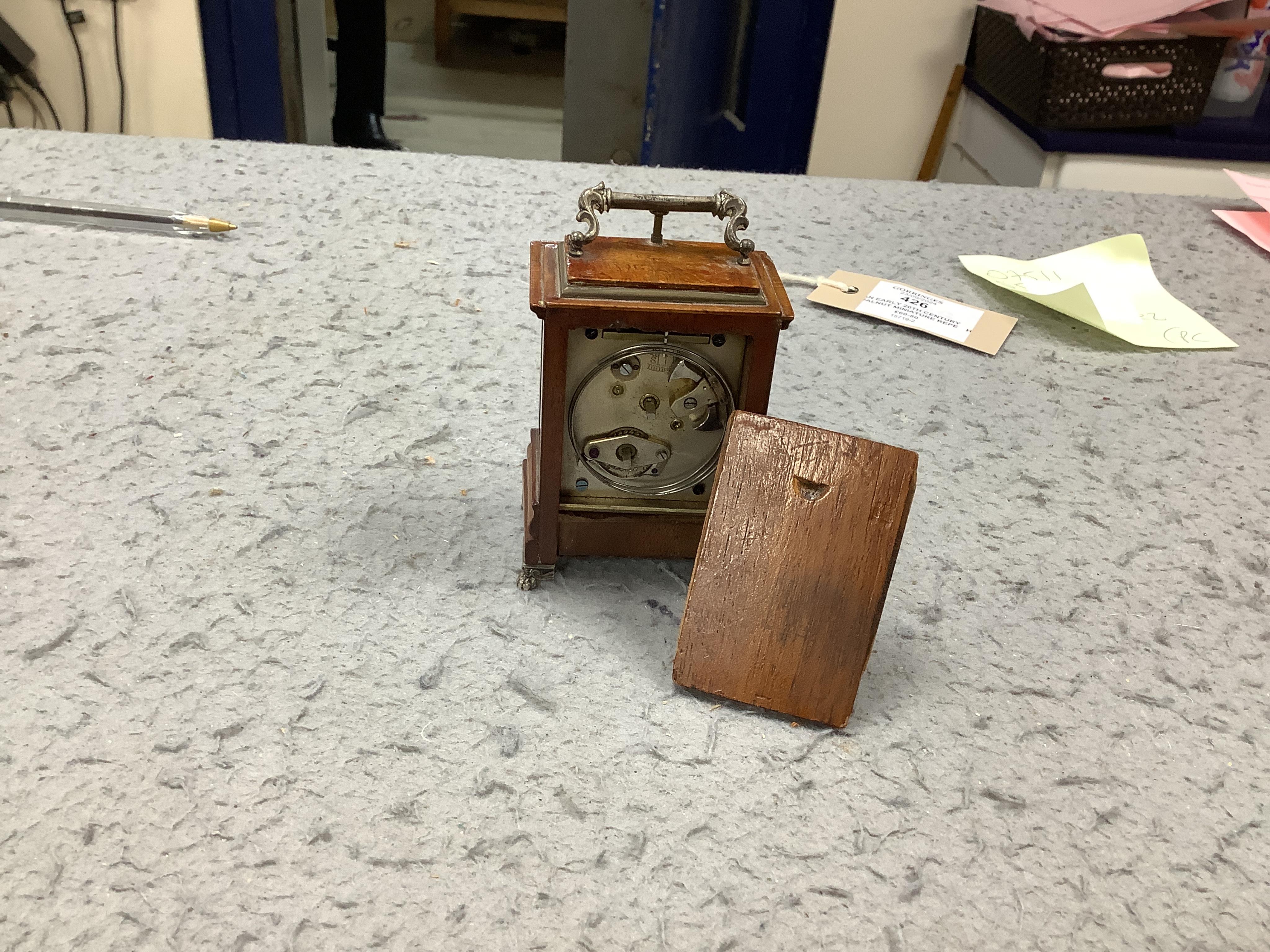 An early 20th century walnut miniature repeating carriage clock, with key, 8.5cm. Condition - fair, currently ticking